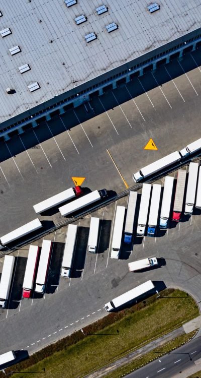 Aerial drone on trucks and logistic center. Warehouse aerial view