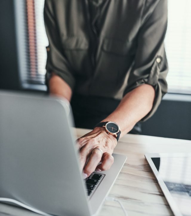 Business, mature person or hands on laptop with typing for article review, editing blog post or copywriting. Freelancer, journalist or story research for creative project, feedback or closeup at desk.